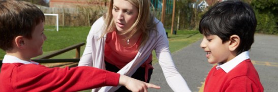 teacher-stopping-bullying-in-playground