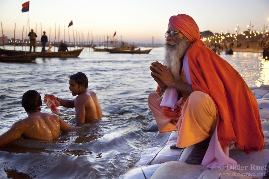 Maha Kumbh Mela. Sanyasi. Bath. Worship. Ganges. Twillight. Sunset.