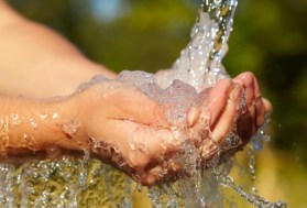 Woman's hands with water splash